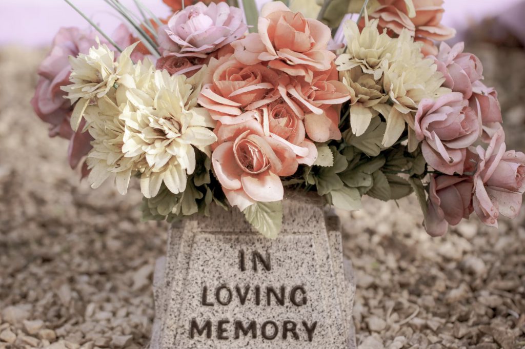 flowers on a gravestone in loving memory, decedent planning
