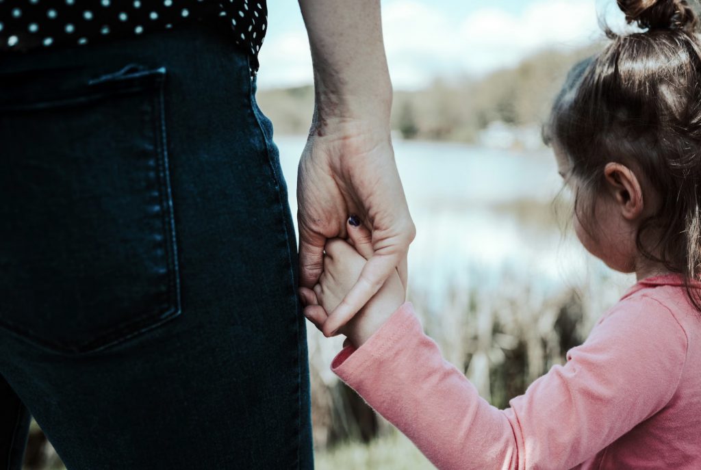 Guardianship - a woman holding a little girl's hand